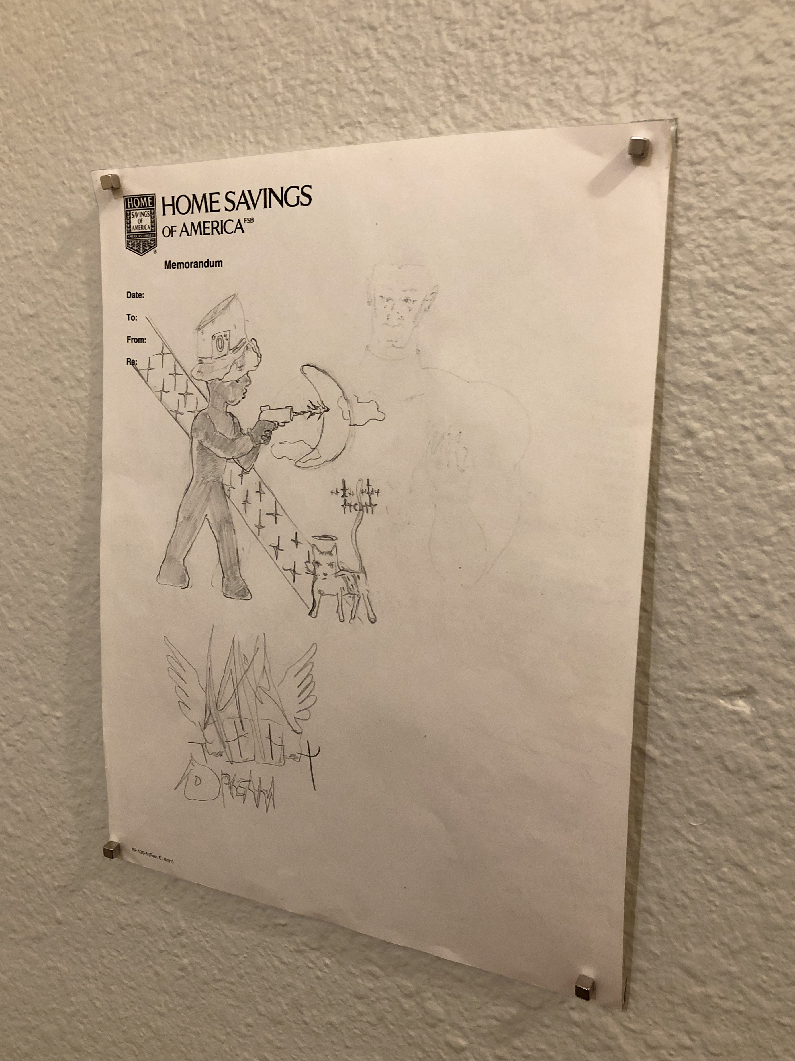 Graphice drawing on a small piece of paper of a young figure with a gun hung on a white wall